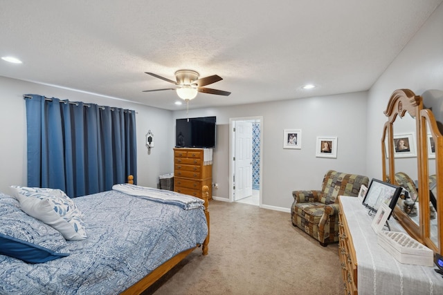 bedroom featuring ceiling fan, carpet floors, and a textured ceiling