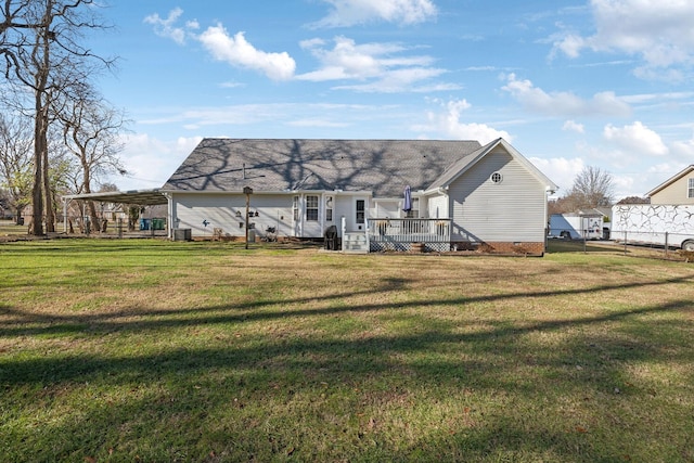 rear view of property featuring a yard and a deck