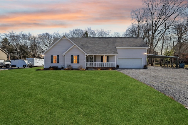 ranch-style home featuring a yard, a garage, a carport, and covered porch