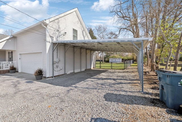 exterior space with a carport and a garage