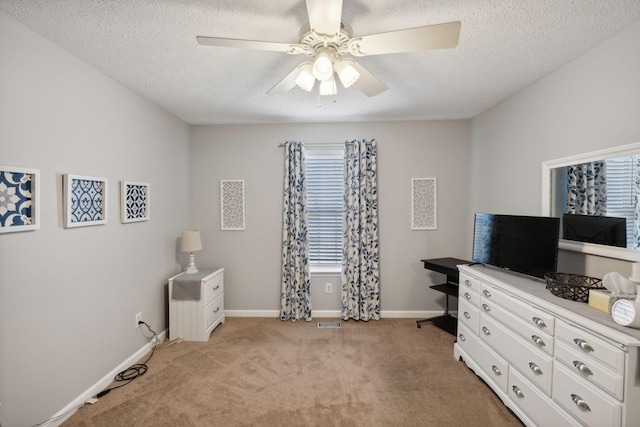 misc room with light colored carpet, a textured ceiling, and ceiling fan