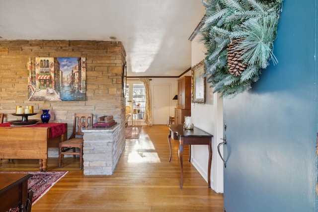 interior space with ornamental molding and light hardwood / wood-style flooring