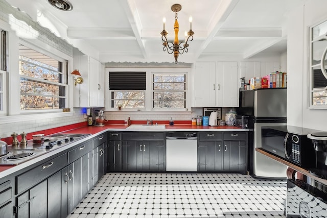 kitchen with decorative light fixtures, appliances with stainless steel finishes, sink, and plenty of natural light