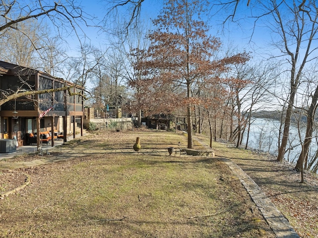 view of yard with a sunroom and central AC