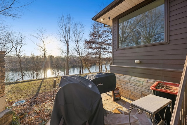 view of patio with a water view and grilling area