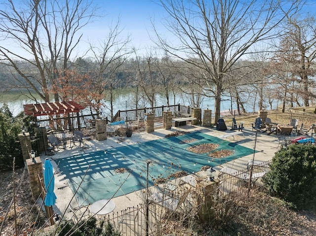 view of pool featuring a patio and a water view