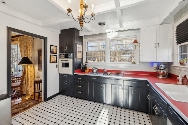 kitchen with plenty of natural light, stovetop, sink, and oven