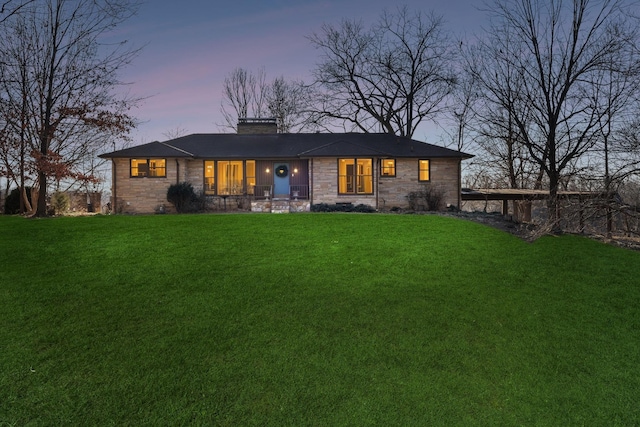 view of front facade with a porch and a lawn