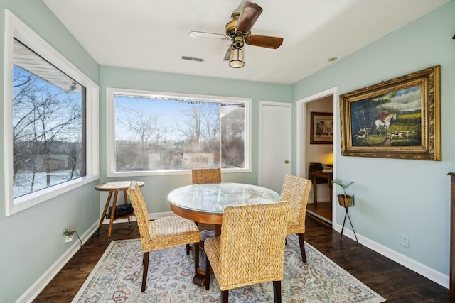 dining room with ceiling fan and dark hardwood / wood-style floors