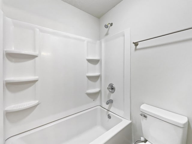 bathroom with toilet and tub / shower combination