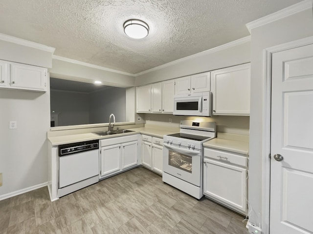 kitchen featuring sink, white appliances, ornamental molding, and white cabinets