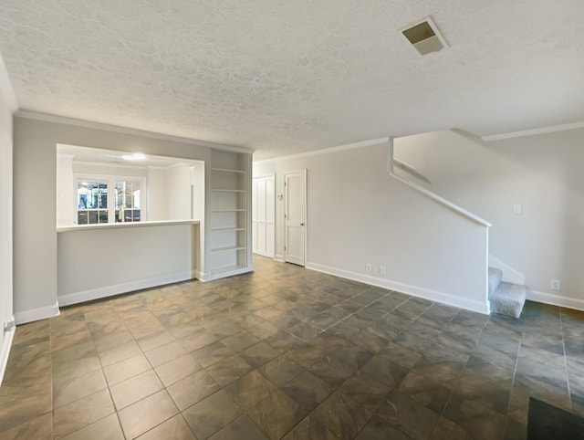 unfurnished living room featuring built in shelves, ornamental molding, and a textured ceiling