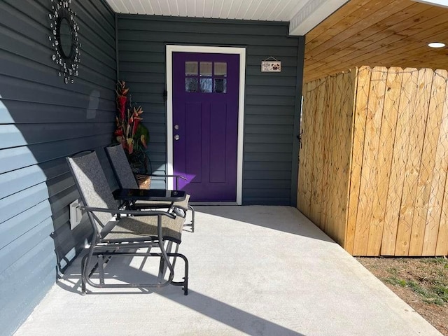 view of exterior entry with covered porch