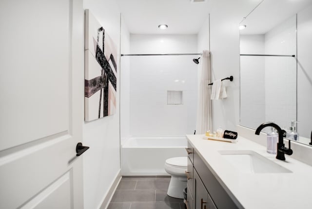 full bathroom featuring vanity, toilet, tiled shower / bath combo, and tile patterned flooring