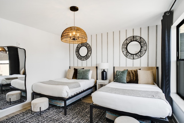 bedroom featuring wood-type flooring and a chandelier