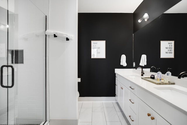bathroom with vanity and a shower with shower door