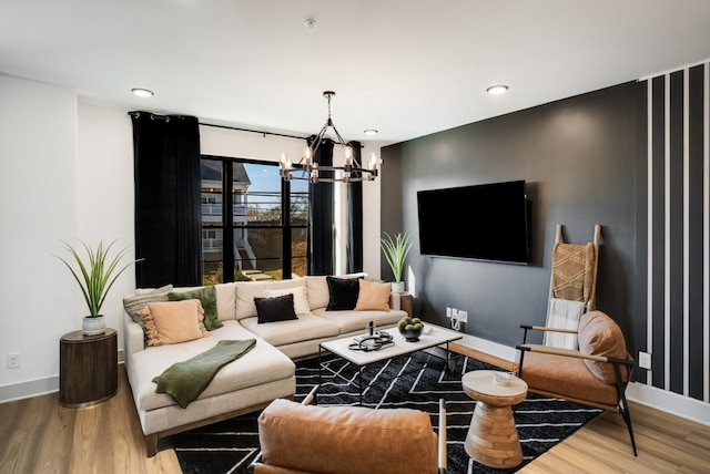 living room with an inviting chandelier and wood-type flooring