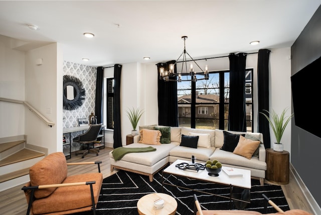 living room featuring a notable chandelier and wood-type flooring