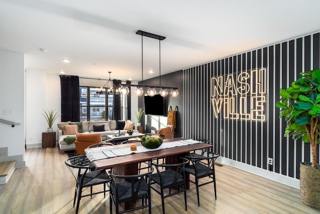 dining space with an inviting chandelier and hardwood / wood-style flooring
