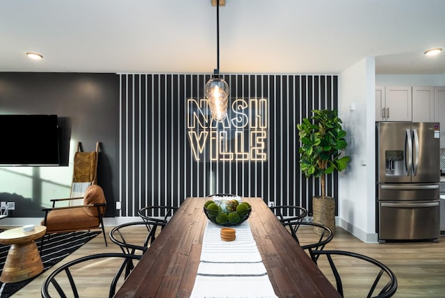 dining area featuring a notable chandelier and light hardwood / wood-style flooring