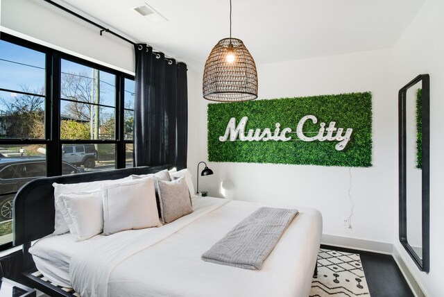 bedroom with hardwood / wood-style floors