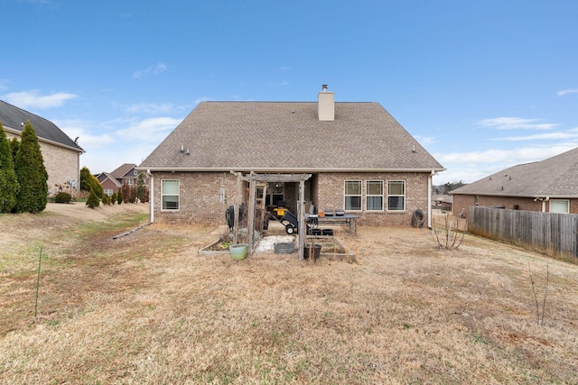 rear view of house with a lawn