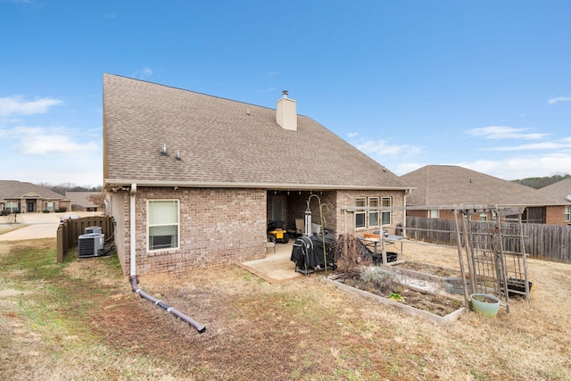 rear view of house with cooling unit and a patio area