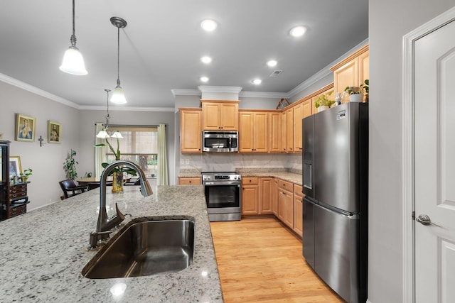 kitchen featuring sink, light stone counters, hanging light fixtures, light brown cabinets, and stainless steel appliances