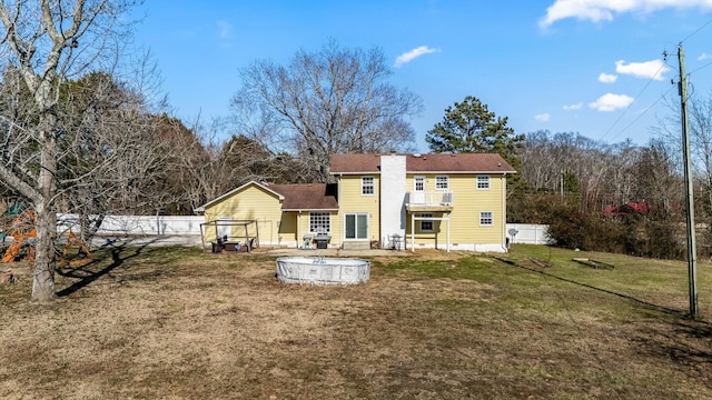 back of property featuring a yard