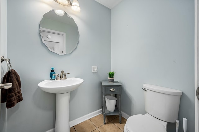 bathroom with tile patterned flooring, sink, and toilet