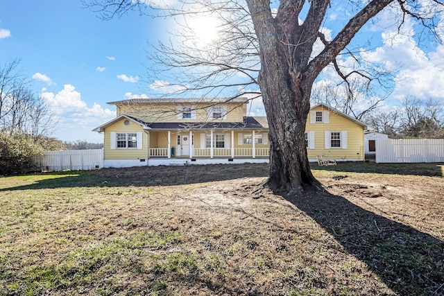 view of front of home with a front yard and covered porch