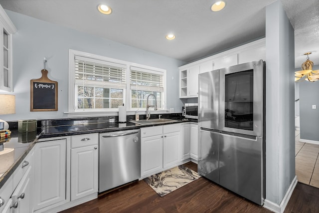 kitchen with white cabinetry, sink, dark wood-type flooring, and appliances with stainless steel finishes