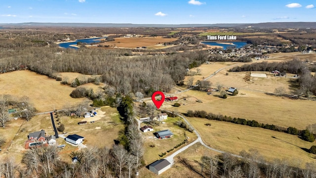 drone / aerial view featuring a water view and a rural view