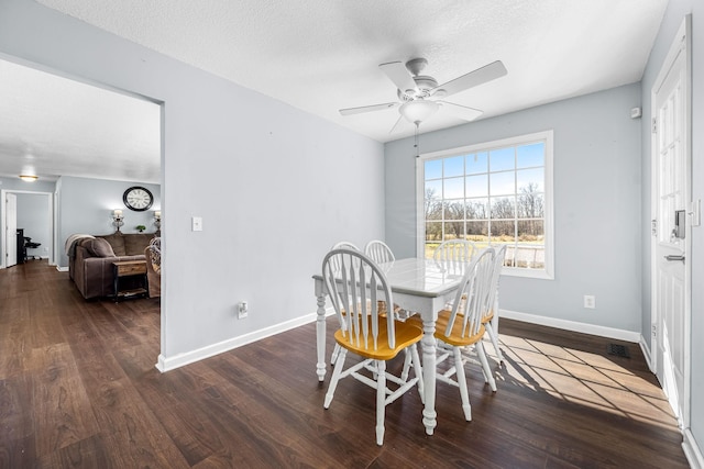 dining area featuring ceiling fan, dark hardwood / wood-style floors, and a textured ceiling