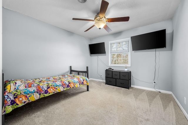 bedroom featuring ceiling fan, carpet flooring, and a textured ceiling