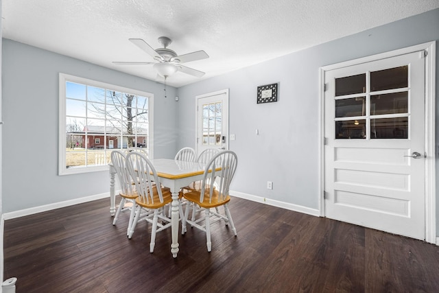 dining room featuring ceiling fan, dark hardwood / wood-style flooring, and a textured ceiling