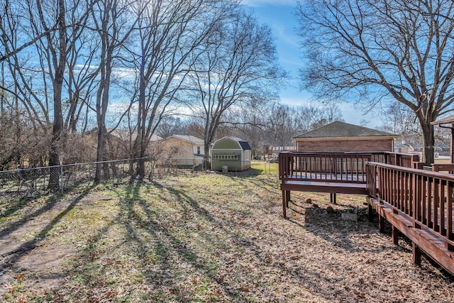 view of yard featuring a wooden deck and an outbuilding