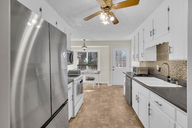 kitchen featuring white cabinetry, appliances with stainless steel finishes, sink, and decorative backsplash