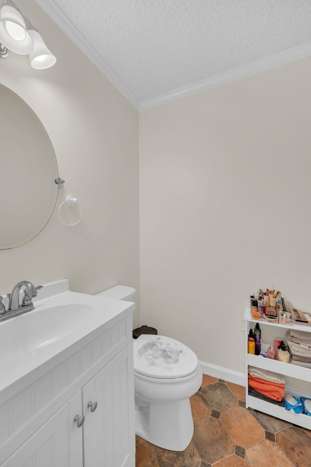 bathroom featuring vanity, ornamental molding, a textured ceiling, and toilet