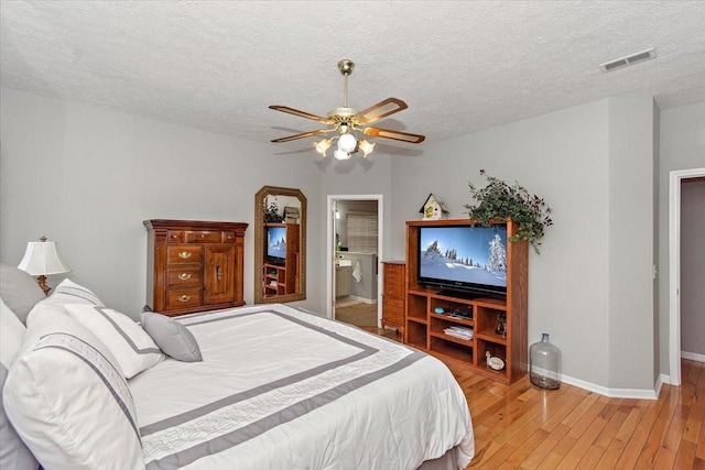 bedroom with wood-type flooring, a textured ceiling, and ceiling fan