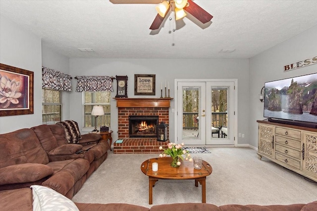 living room with a healthy amount of sunlight, a fireplace, light carpet, and a textured ceiling