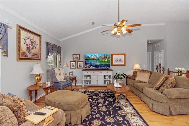 living room with hardwood / wood-style flooring, ceiling fan, crown molding, and vaulted ceiling