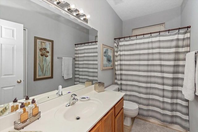 bathroom featuring vanity, a textured ceiling, toilet, and walk in shower