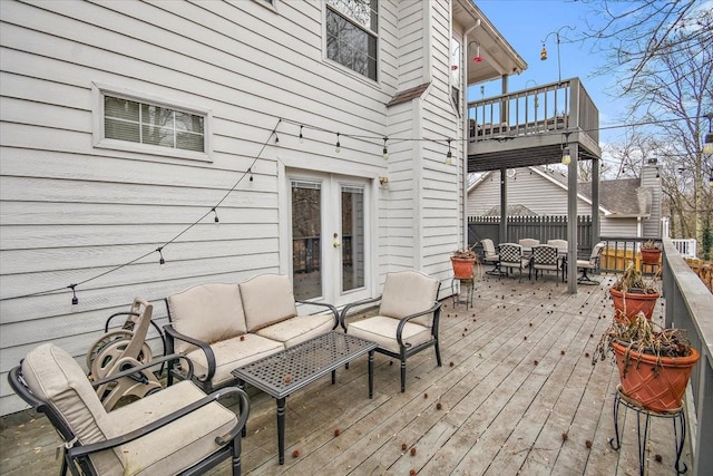 deck with french doors and an outdoor hangout area