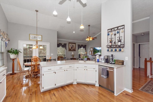 kitchen with stainless steel dishwasher, kitchen peninsula, pendant lighting, ceiling fan, and white cabinets