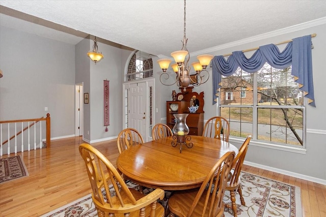 dining room featuring hardwood / wood-style flooring, a textured ceiling, and a chandelier