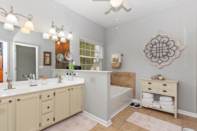 bathroom featuring tile patterned floors, a textured ceiling, vanity, ceiling fan, and a washtub