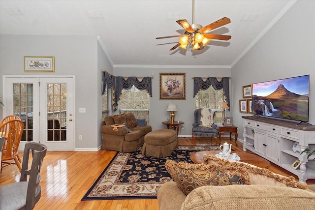 living room featuring ceiling fan, crown molding, light hardwood / wood-style flooring, and a healthy amount of sunlight