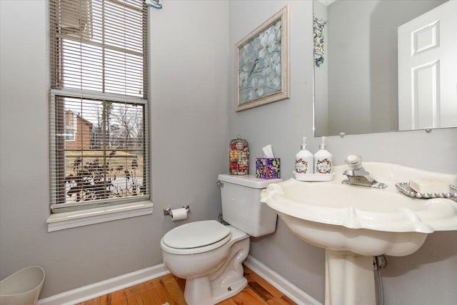 bathroom with hardwood / wood-style flooring and toilet