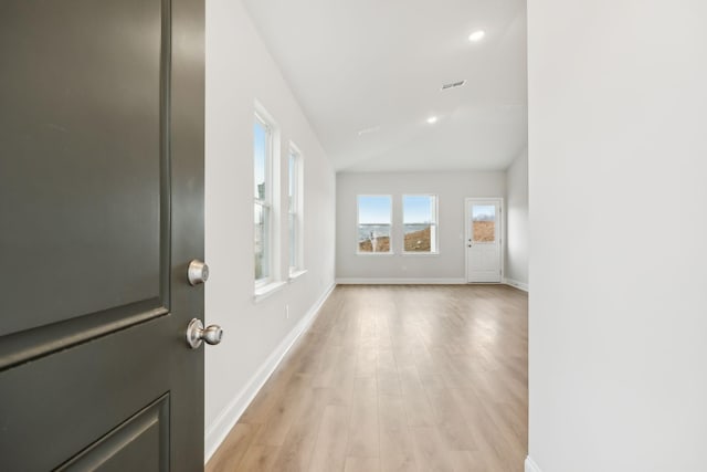 interior space with vaulted ceiling and light hardwood / wood-style floors